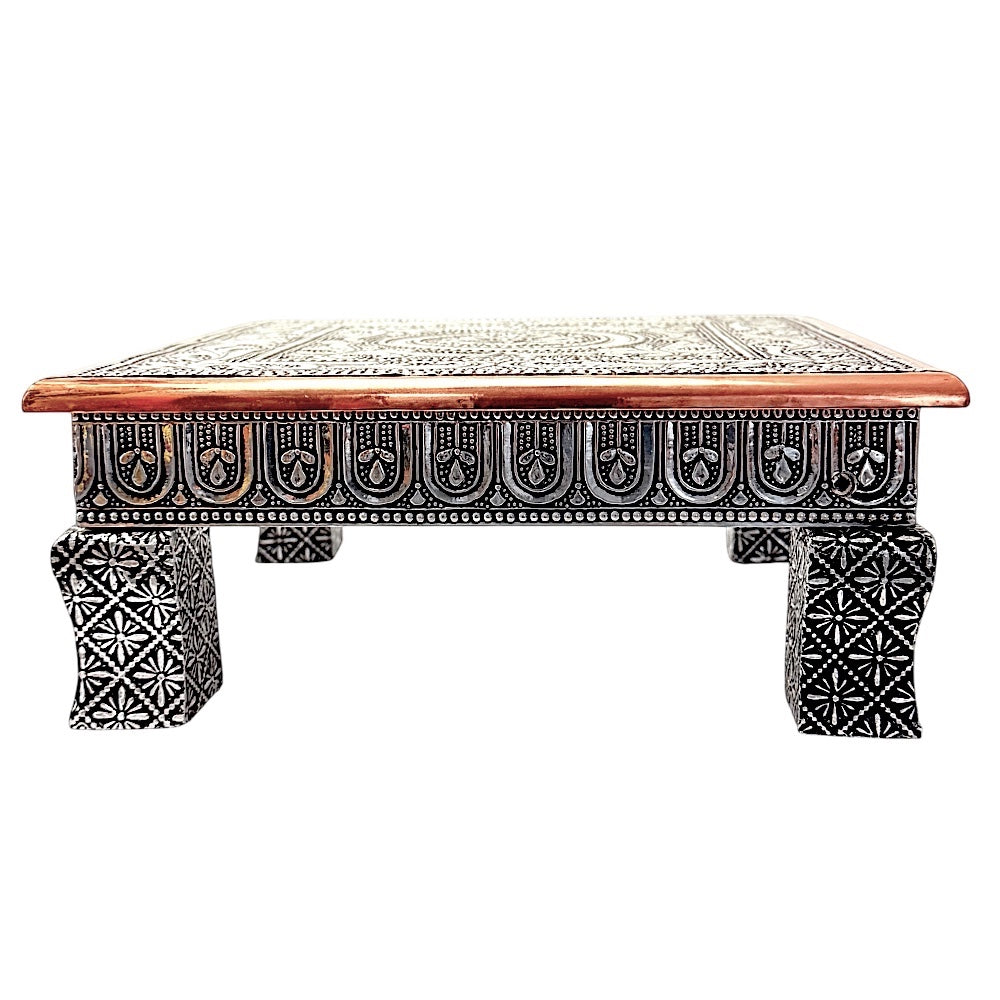 Quality Indian Goods Bajat Oxidised 10 inch square puja table with short legs, featuring intricate silver-tone metalwork and a copper-toned wooden border.