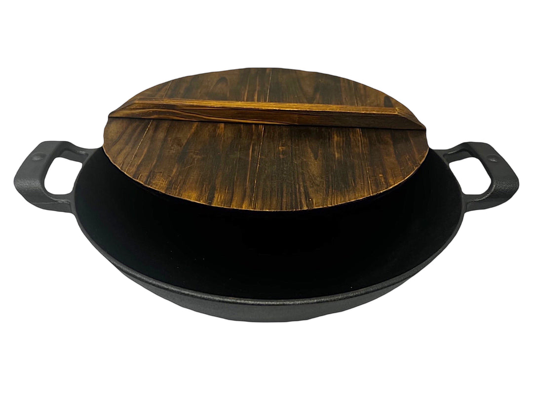 Black cast iron wok 13.25 inch, with wooden lid, ideal for stir-frying and Asian cooking.