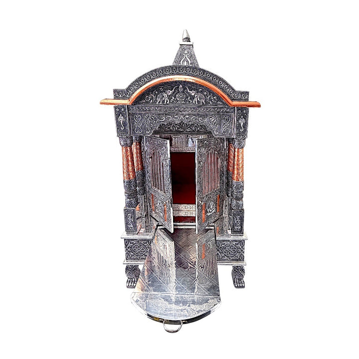 Quality Indian Goods 18-inch wide oxidized silver mandir with intricate carvings and copper accents. Features double doors and a pull-out tray.