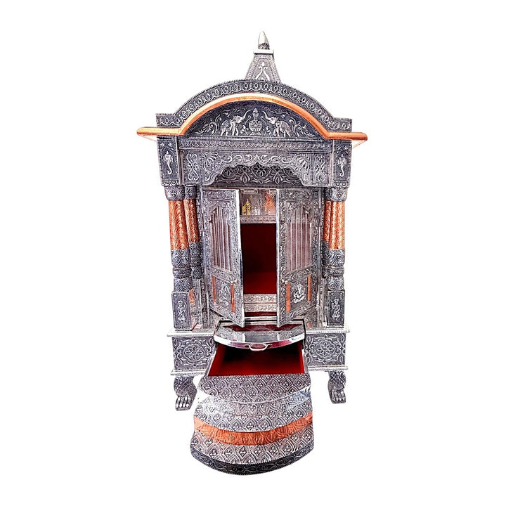 Quality Indian Goods 18-inch wide oxidized puja mandir with intricate carvings and copper accents. Features double doors and a red-lined drawer.